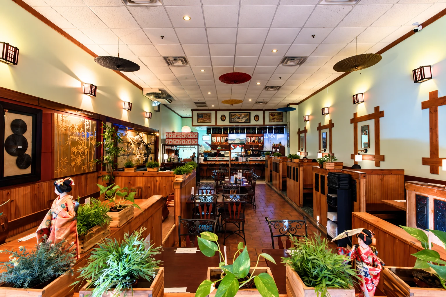 Wood booths, plants and lantern-style lights inside Midori Sushi