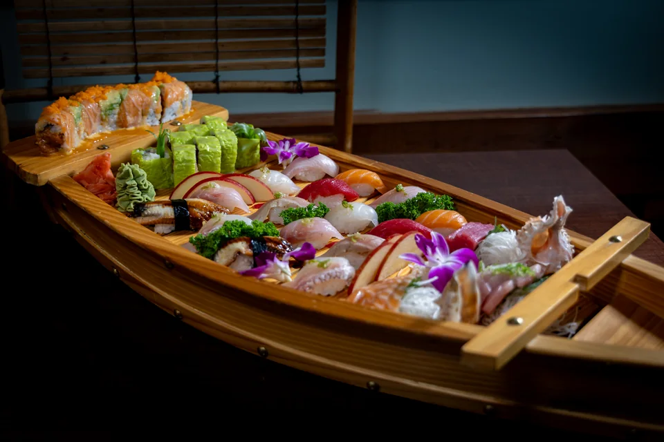 Midori Sushi Family Boat with sushi, sashimi and signature rolls on a wooden boat